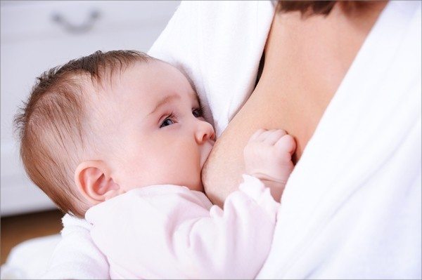 Close-up portrait of breastfeeding for little newborn baby - indoors